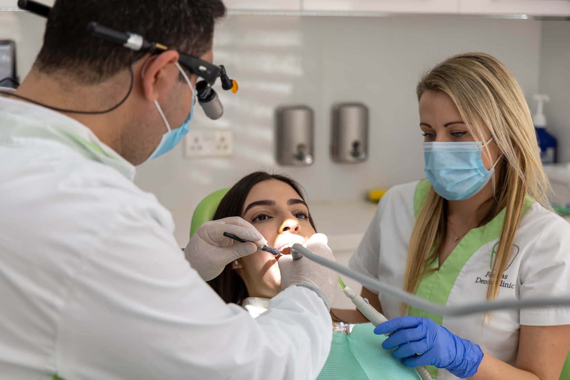 Dr. Savvas Farfaras and Agnes treating a patient at the clinic
